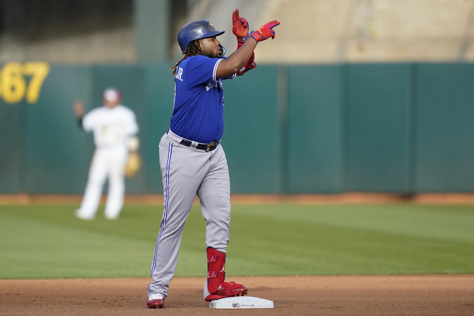 Toronto Blue Jays' Vladimir Guerrero Jr. gestures after hitting a double against the Oakland Athletics during the fourth inning of a baseball game in Oakland, Calif., Monday, July 4, 2022. (AP Photo/Jeff Chiu)