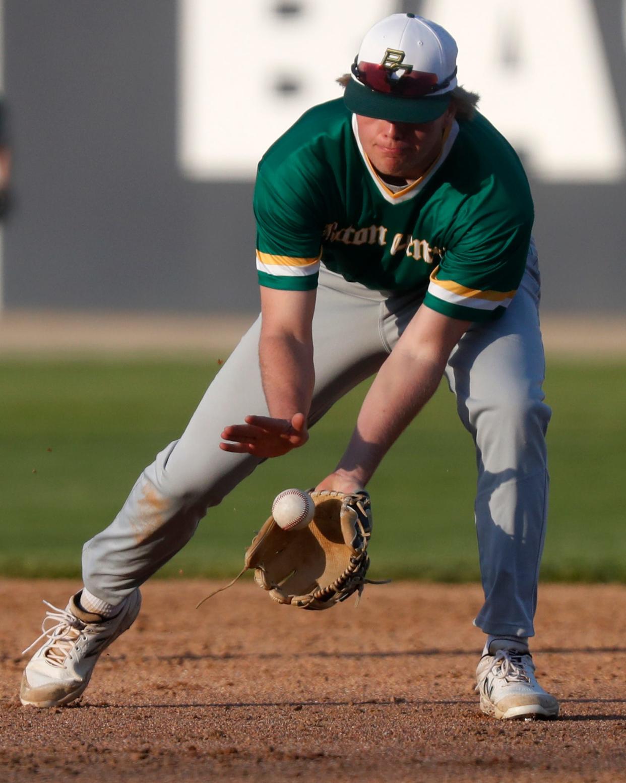 Benton Central Bison Boston Pritchett (5) fields a ground ball during the IHSAA baseball game against the Central Catholic Knights, Tuesday, April 11, 2023, at Central Catholic High School in Lafayette, Ind. Central Catholic won 8-6.