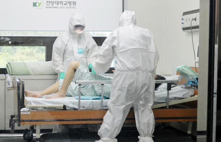 Medical workers care for a MERS patient at Konyang University Hospital in Daejeon, 140 km south of Seoul, on June 7, 2015