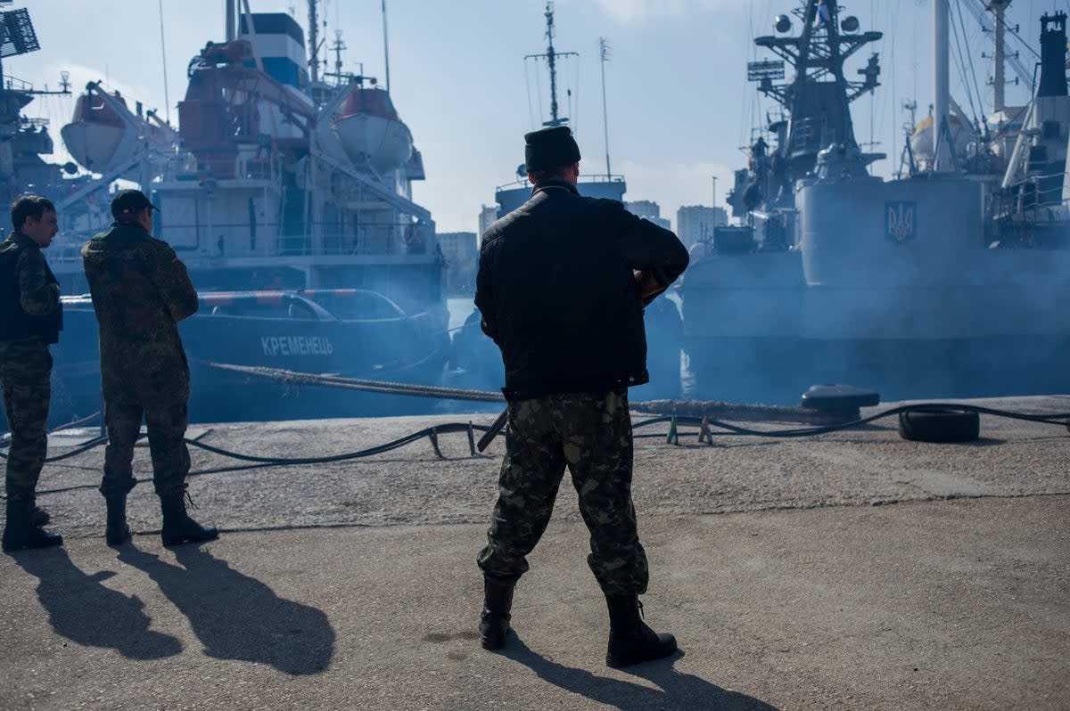 Men in unmarked uniforms stand guard during the seizure of the Ukrainian corvette Khmelnitsky in Sevastopol, Crimea, in March 2014 (Copyright 2014 The Associated Press. All rights reserved)