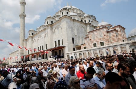 People attend a symbolic funeral prayer for the former Egyptian president Mursi in Istanbul