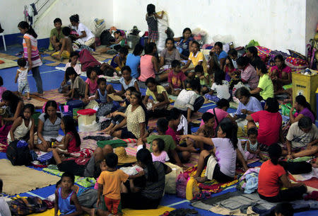Evacuees from the coastal villages take shelter inside an evacuation center as Typhoon Haima locally name Lawin approaches, in Alcala town, Cagayan province, north of Manila October 19, 2016. REUTERS/Stringer