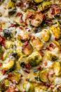 <p>The one side that will make everyone freak out (and run for seconds). If you have vegetarian guests, feel free to skip the bacon! We're all about the smoky flavour, but for this dish, it's all about the CHEESE.</p><p>Get the <a href="https://www.delish.com/uk/cooking/recipes/a28924372/cheesy-brussels-sprout-casserole-recipe/" rel="nofollow noopener" target="_blank" data-ylk="slk:Cheesy Brussels Sprout Bake;elm:context_link;itc:0;sec:content-canvas" class="link ">Cheesy Brussels Sprout Bake</a> recipe.</p>