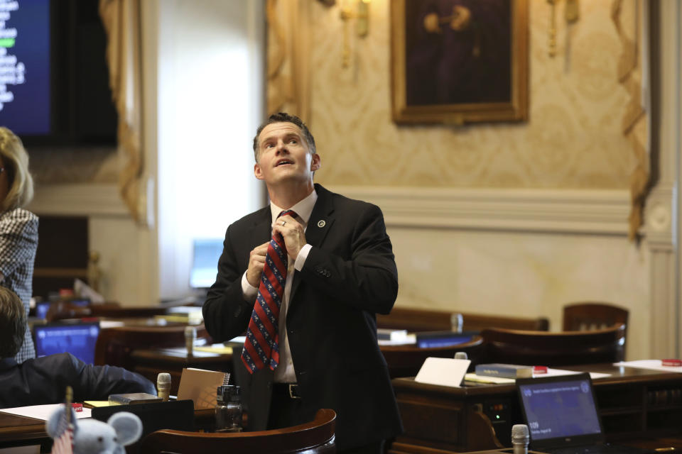 South Carolina Rep. Stewart Jones, R-Laurens, straightens his tie before a House session on a total ban on abortion on Tuesday, Aug. 30, 2022, in Columbia, S.C (AP Photo/Jeffrey Collins)