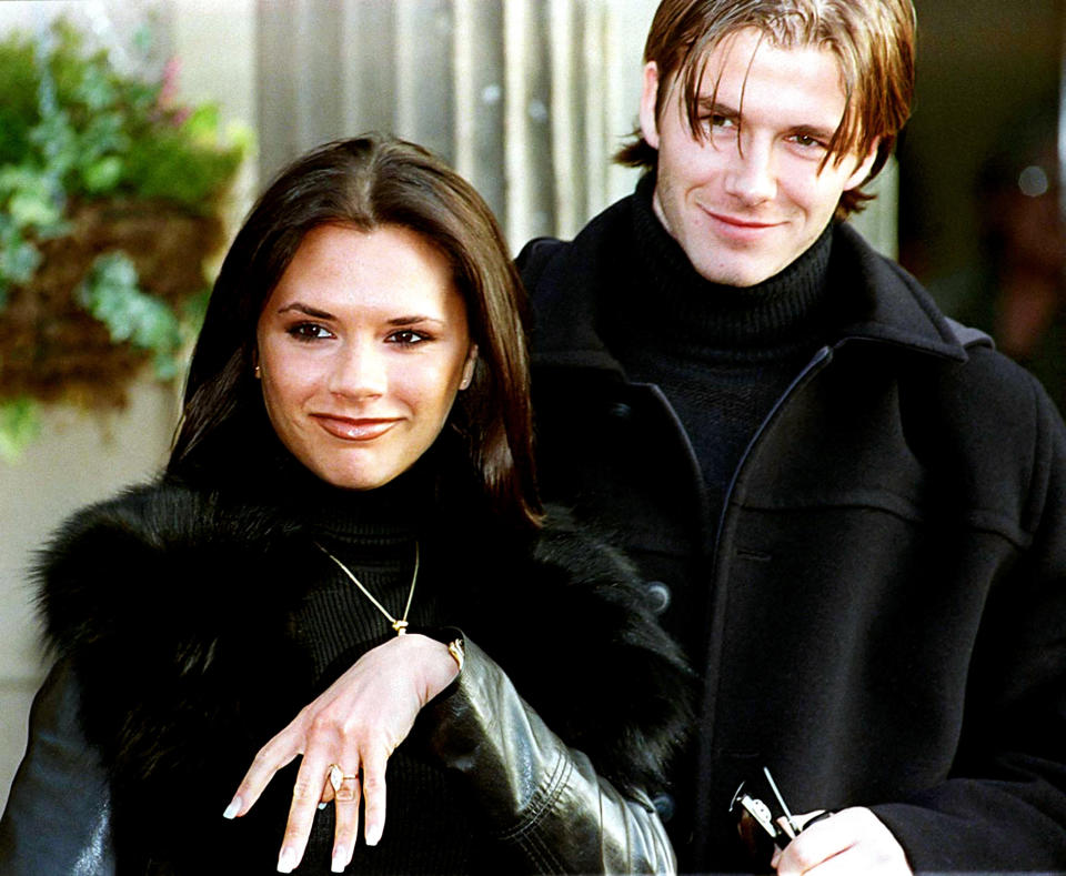 The couple in matching black turtlenecks as they announce their engagement in 1998.