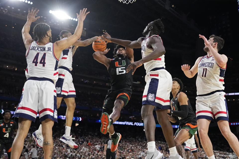 Miami forward Norchad Omier is blocked by Connecticut during the second half of a Final Four college basketball game in the NCAA Tournament on Saturday, April 1, 2023, in Houston. (AP Photo/Brynn Anderson)
