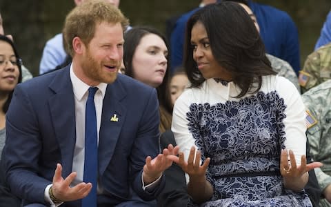 Prinace Harry and Michelle Obama in 2015 at the Wounded Warrior games - Credit: AFP
