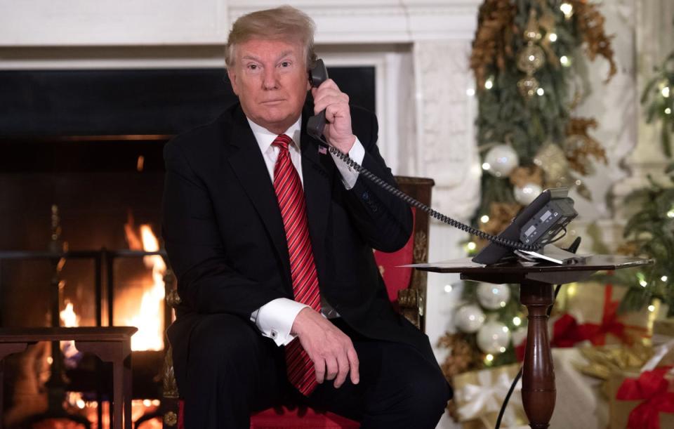Former US president Donald Trump taking part in the Norad Santa-tracking tradition in 2018 (Saul Loeb/AFP via Getty Images)