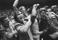 FILE - Indiana coach Bob Knight, right, celebrates with the team and fans after the team's win over Marquette in the NCAA men's college basketball tournament Mideast regionals in Baton Rouge, La., in March 1976. Knight, the brilliant and combustible coach who won three NCAA titles at Indiana and for years was the scowling face of college basketball, has died. He was 83. Knight's family made the announcement on social media on Wednesday night, Nov. 1, 2023, saying he was surrounded by family members at his home in Bloomington, Ind. (AP Photo, File)