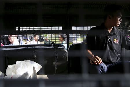 A forensic policeman transports body bags with human remains found at the site of human trafficking camps in the jungle close the Thailand border after bringing them to a police camp near Wang Kelian in northern Malaysia in this May 25, 2015 file photo. REUTERS/Damir Sagolj/Files