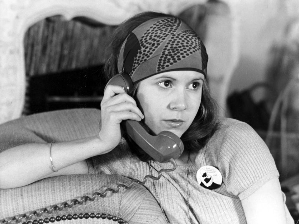 Carrie Fisher chatted on the phone in a scene from her first film, 1975's <em>Shampoo</em>.