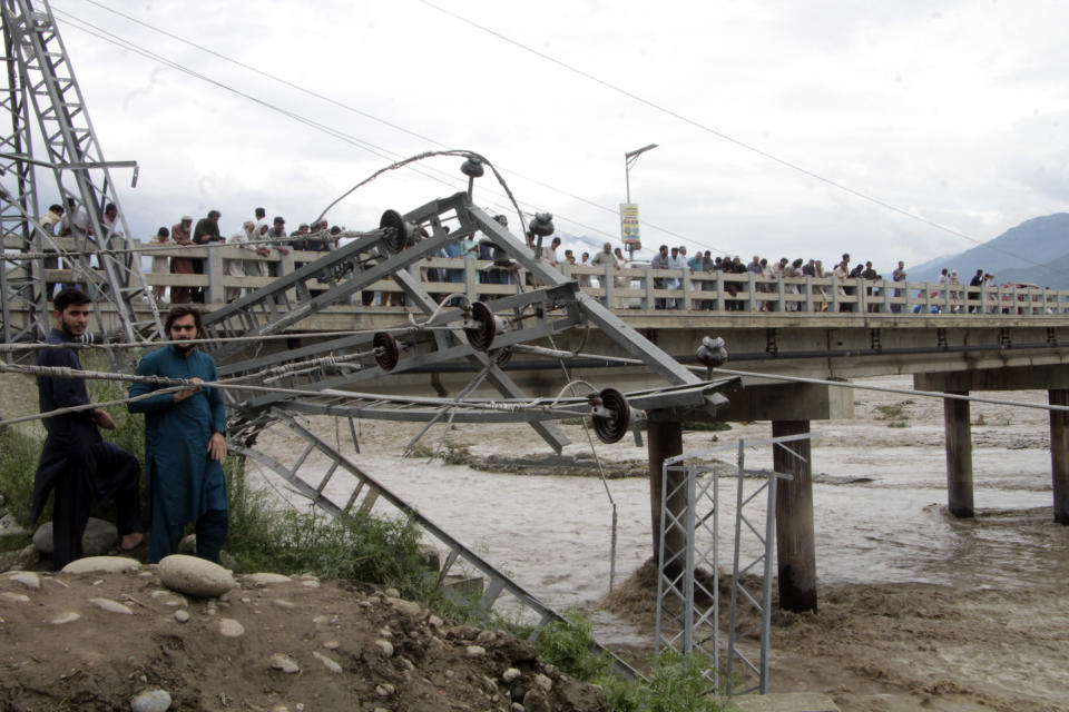 Damaged electrical towers on the ground after being damaged during the floods in Mingora, the capital of Swat valley in Pakistan, Saturday, Aug. 27, 2022. Officials say flash floods triggered by heavy monsoon rains across much of Pakistan have killed nearly 1,000 people and displaced thousands more since mid-June. (AP Photo/Naveed Ali)