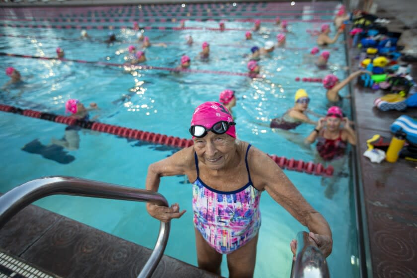 PASADENA, CA - NOVEMBER 27: Maurine Kornfeld, 100, is getting into the pool for the 6:30am Master's swim practice at Rose Bowl Aquatics Center on Saturday, Nov. 0, 27, 2021 in Pasadena, CA. Maurine, known to her team as "Mo" just turned 100 and her team is celebrating. Kornfield is a real inspiration for her swimteam and her team is commemorating her 100th birthday. (Francine Orr / Los Angeles Times)