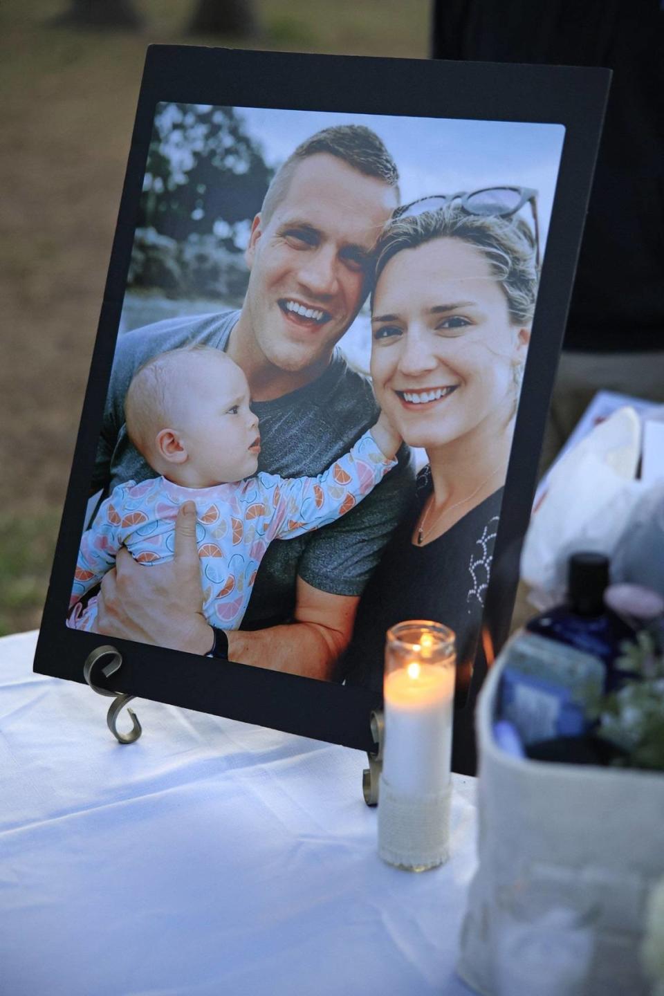 A family portrait of Jared and Kirsten Bridegan with their now 2-year-old daughter Bexley is displayed at Tuesday’s candlelight vigil in memory of the 33-year-old husband and father. He was shot and killed on Feb. 16 near the exit of The Sanctuary neighborhood in Jacksonville Beach in front of Bexley, police and family said. Jki 042122 Jaxbeachvigil 0 4