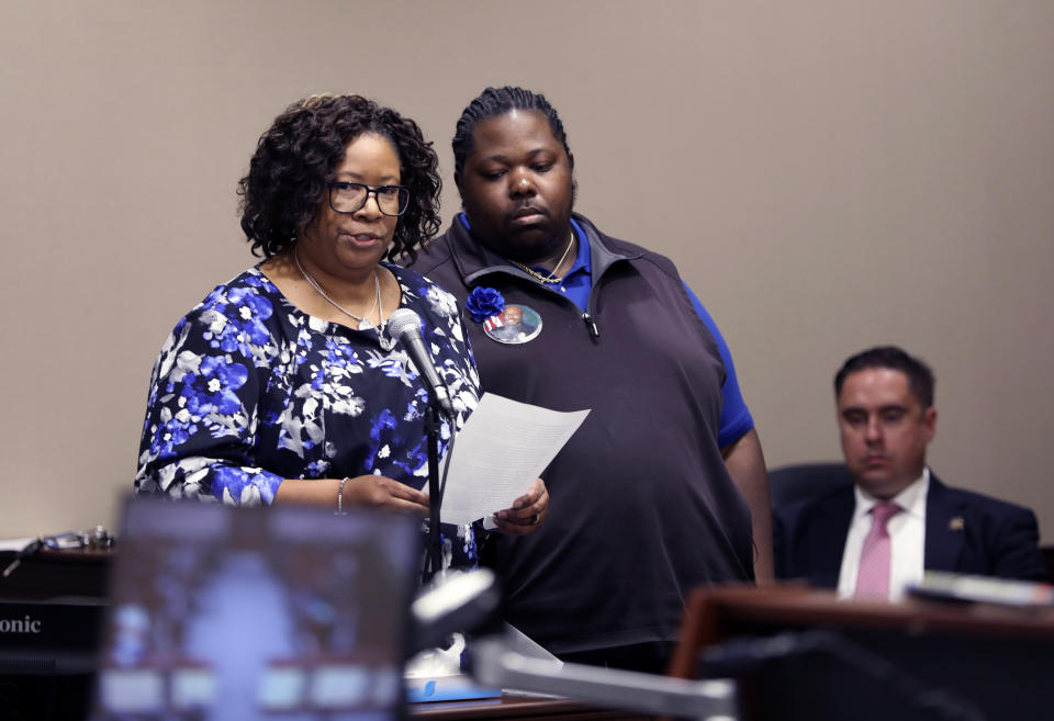 Allison Carraway, left, talks about her husband police officer Terrence Caraway, who was killed in an ambush as her son. Rashad Carraway, listens in Florence, S.C., on Thursday, Oct. 19, 2023. Frederick Hopkins was sentenced to life in prison without parole for killing Carraway and another officer and wounding five others in an October 2018 ambush at his Florence home (AP Photo/Jeffrey Collins).