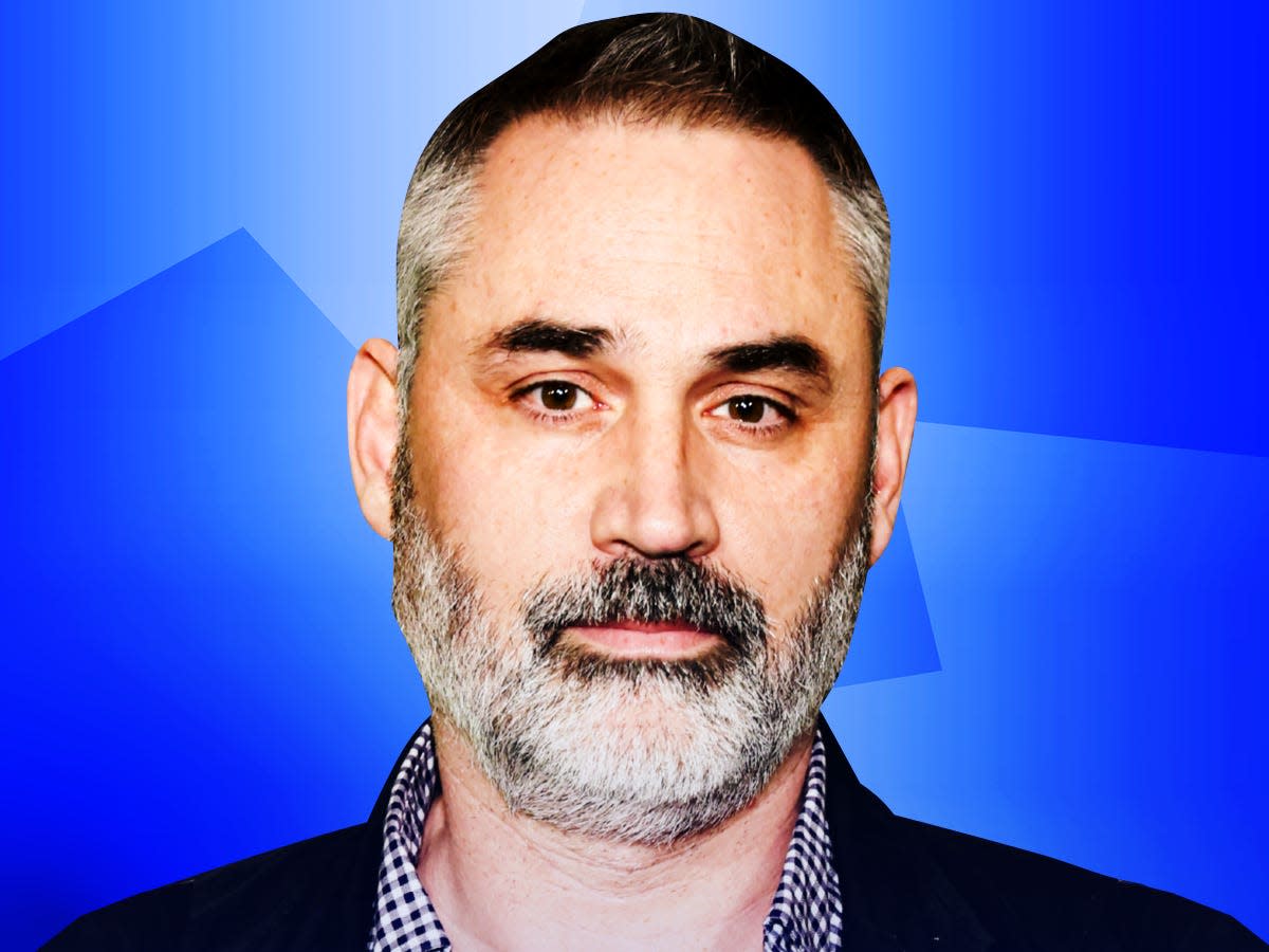 Alex Garland, an English novelist, screenwriter, film producer and director on a blue background