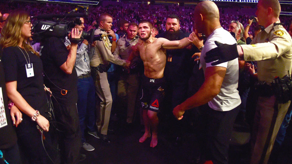 Khabib Nurmagomedov is escorted out of the arena after defeating Conor McGregor. (Photo by Harry How/Getty Images)