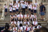 Students wearing face masks to protect against the coronavirus sit on steps at the Temple of Heaven in Beijing, Saturday, July 18, 2020. Authorities in a city in far western China have reduced subways, buses and taxis and closed off some residential communities amid a new coronavirus outbreak, according to Chinese media reports. They also placed restrictions on people leaving the city, including a suspension of subway service to the airport. (AP Photo/Mark Schiefelbein)