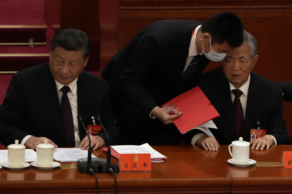 Chinese President Xi Jinping at left looks on as former Chinese President Hu Jintao is assisted to leave the hall during the closing ceremony of the 20th National Congress of China's ruling Communist Party at the Great Hall of the People in Beijing, Saturday, Oct. 22, 2022. Former Chinese President Hu Jintao, Xi's predecessor as party leader, was helped off the stage shortly after foreign media came in, sparking speculation about his health. (AP Photo/Ng Han Guan)