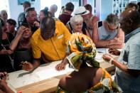 A Thomas Cook travel representative helps tourists prepare to leave the Gambia after the British Government changed the travel advisory to amber due to the state of emergency in the country on January 18, 2017