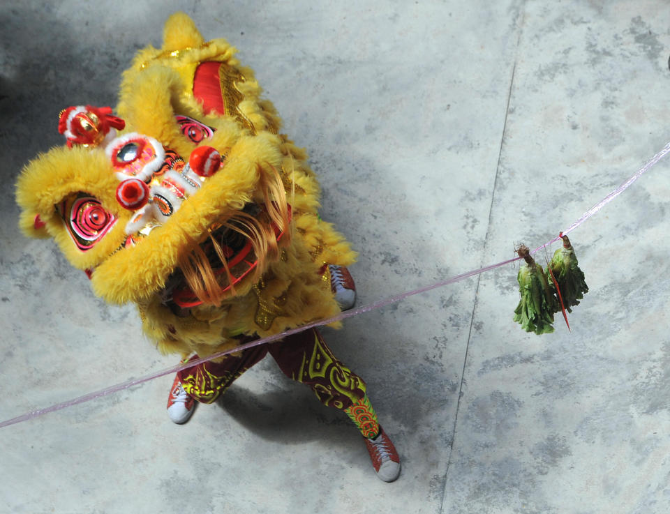 A lion dance performer performing a 