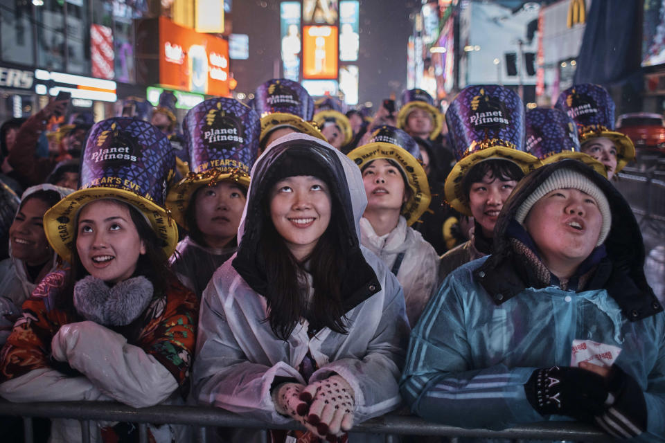 Revellers gather under the rain as they wait for the countdown during the New Year's Eve celebrations in Times Square on Saturday, Dec. 31, 2022, in New York. (AP Photo/Andres Kudacki)