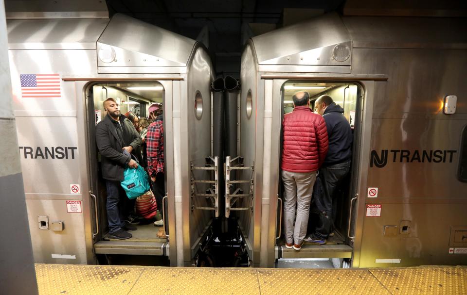 Homebound commuters crowd on to an NJ Transit train during the evening commute at Penn Station Nov. 27, 2019.