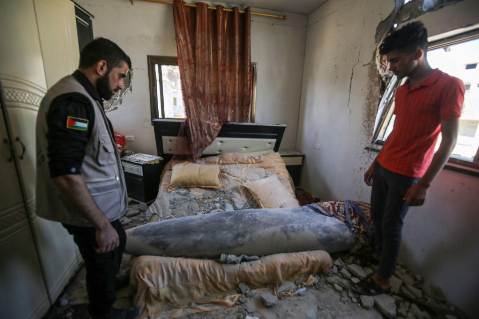 Units of the Palestinian Interior Ministry try to neutralise a missile launched by Israel that did not explode after hitting the bedroom of a house in Khan Yunis, Gaza.