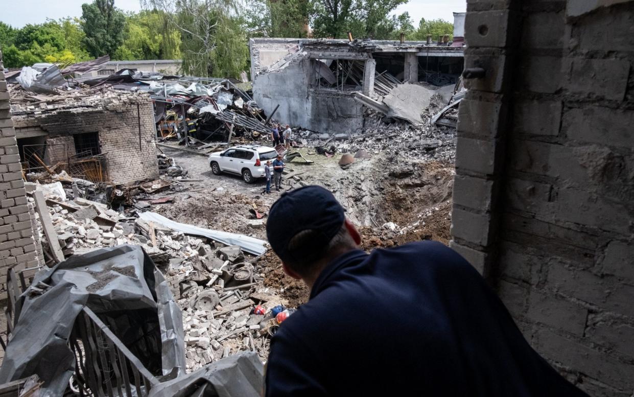 Ukrainian firefighter observes the damage left behind by a missile strike at a building that housed a fire station and a laboratory that was struck overnight in a round of fresh strikes in Dnipro city - Anadolu/Anadolu Agency