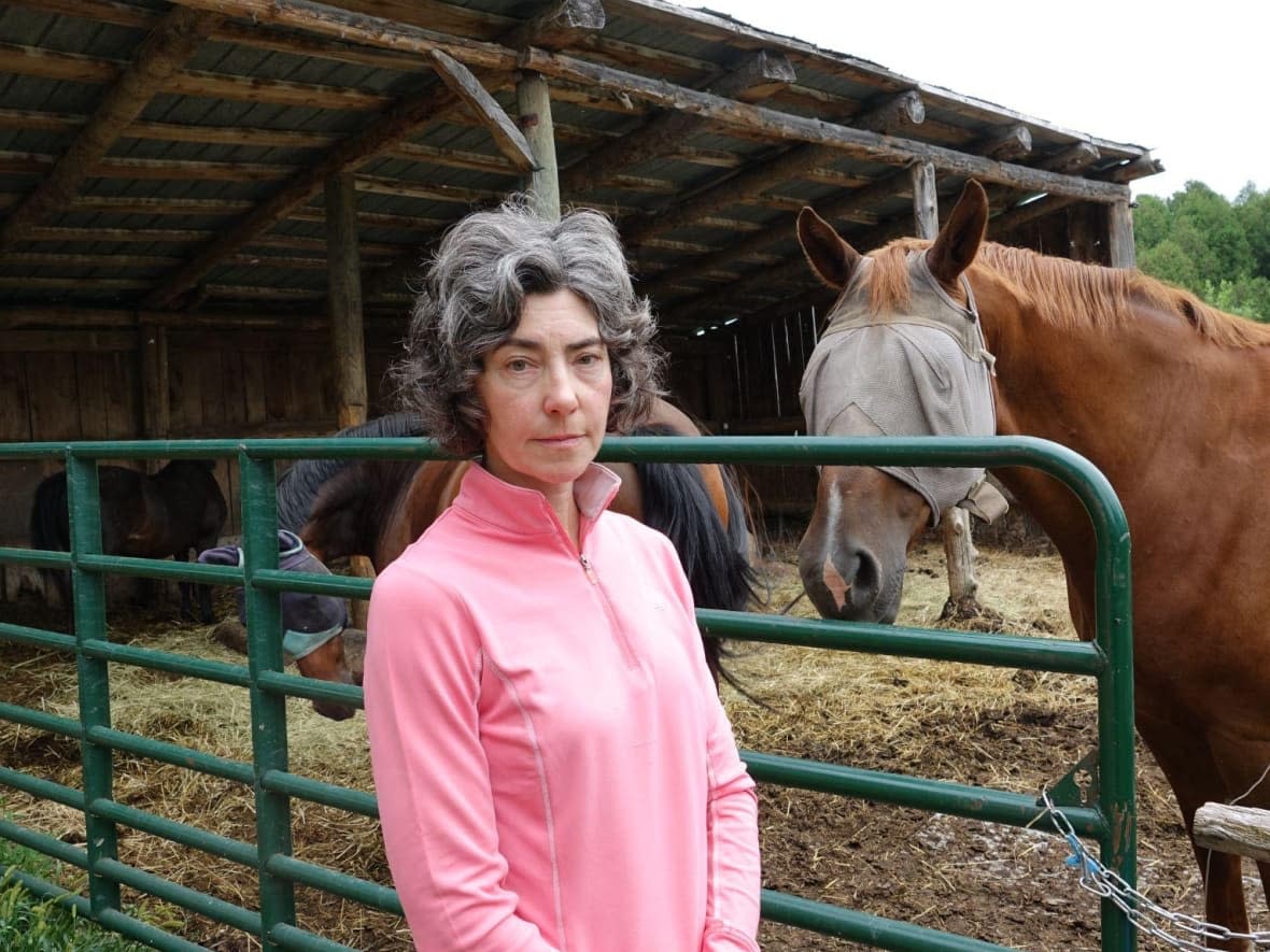 Stephanie Sitzberger stands outside on her property in Gatineau. She is one of several Pontiac horse owners trying to find solutions to the absence of large-animal veterinary care in the region. (Rachel Watts/CBC - image credit)