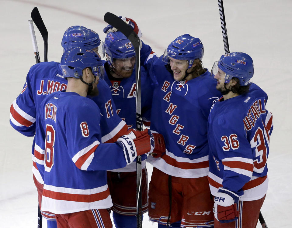 New York Rangers left wing Carl Hagelin (62) celebrates his goal with teammates Kevin Klein (8), John Moore (17), Brad Richards (19), and Mats Zuccarello during the first period of Game 6 of a second-round NHL playoff hockey series against the Pittsburgh Penguins, Sunday, May 11, 2014, in New York. (AP Photo/Seth Wenig)