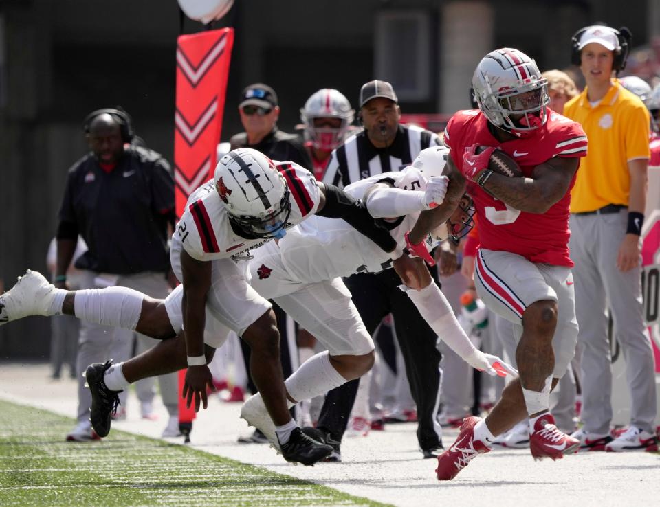 September 10, 2022; Columbus, Ohio, USA; Ohio State Buckeyes running back Miyan Williams (3) is tackled by Arkansas State Red Wolves linebacker Melique Straker (21) and Arkansas State Red Wolves linebacker Kivon Bennett (5) during the second half of Saturday's game at Ohio Stadium.Mandatory Credit: Barbara J. Perenic/Columbus Dispatch