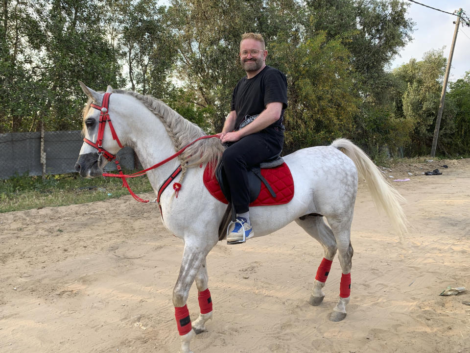 Associated Press journalist Fares Akram rides a horse outside his family’s farm in 2020, in the northern Gaza Strip. An Israeli airstrike smashed into the property on Friday, May 14, 2021, leaving a jagged mass of metal and splintered trees. (Akram Family via AP)