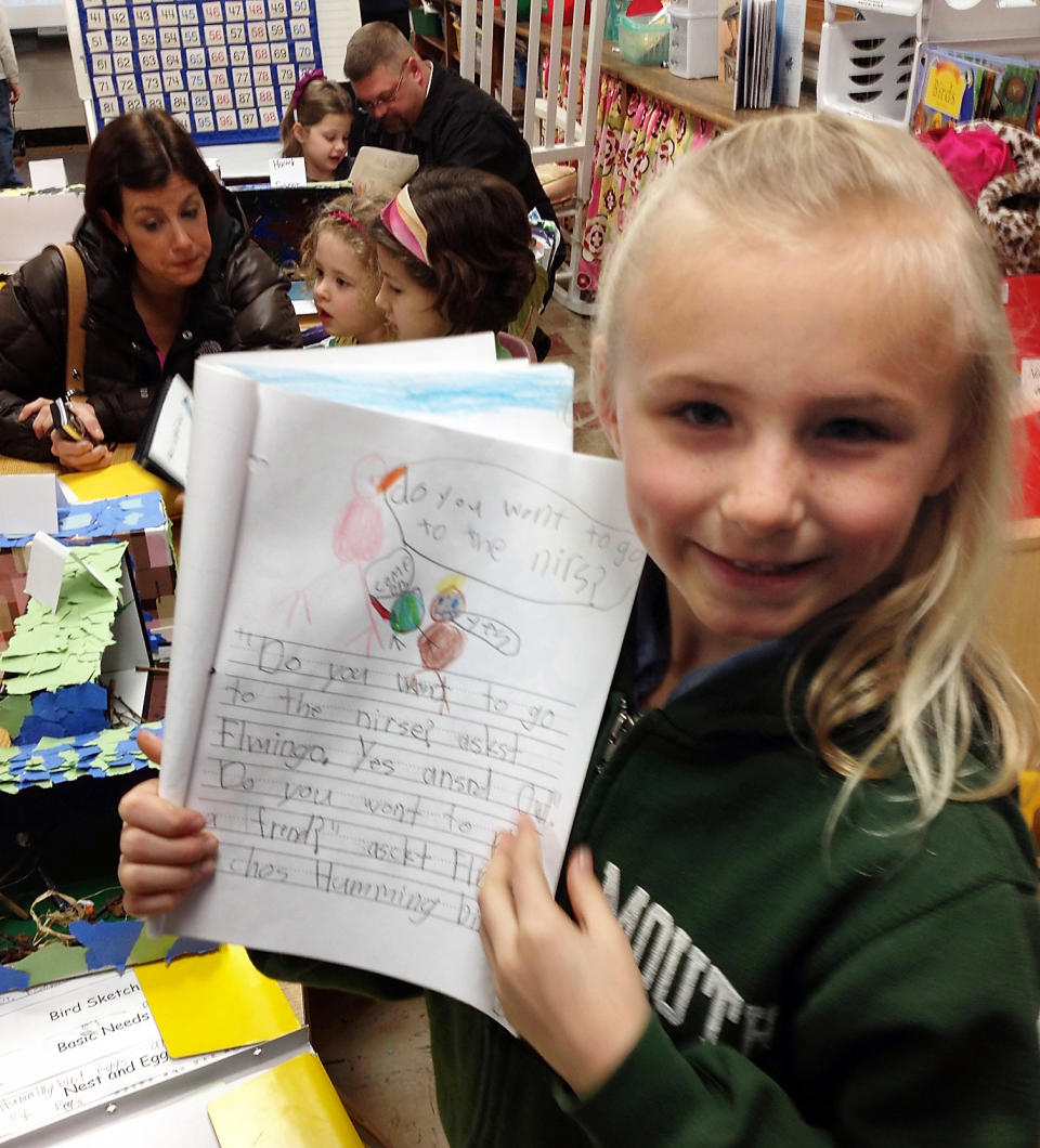 This undated image provided by Elsje Eisenhauer shows Emma Eisenhauer, 6, posing with her first grade project of a hummingbird at Freemont Elemntary School in Columbus, Ohio. Some people call hummingbirds "flying jewels," said Emma. When her first grade teacher at Fremont Elementary School asked students to choose a bird to study all year, Emma chose the hummingbird because her mom, Elsje, is so fond of hummingbird cake. (AP Photo/ Elsje Eisenhauer)