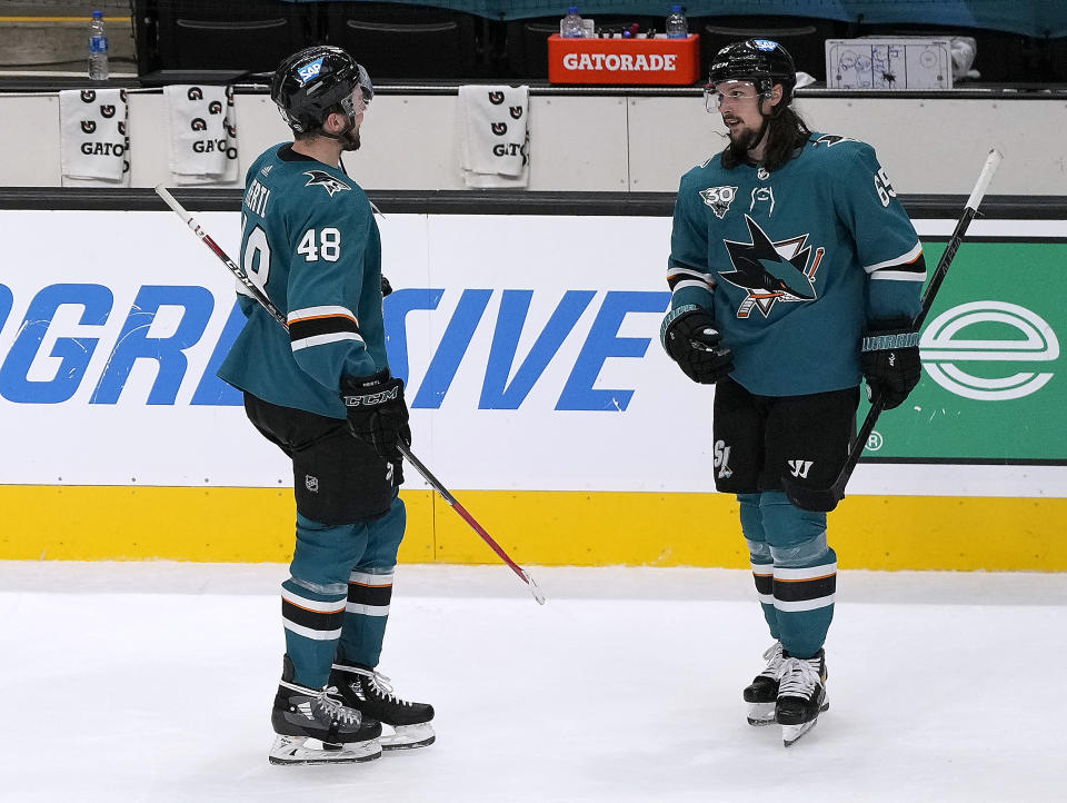 San Jose Sharks defenseman Erik Karlsson (65) is congratulated by teammate Tomas Hertl (48) after scoring the winning goal against the Minnesota Wild in a shootout in an NHL hockey game in San Jose, Calif., Monday, March 29, 2021. (AP Photo/Tony Avelar)