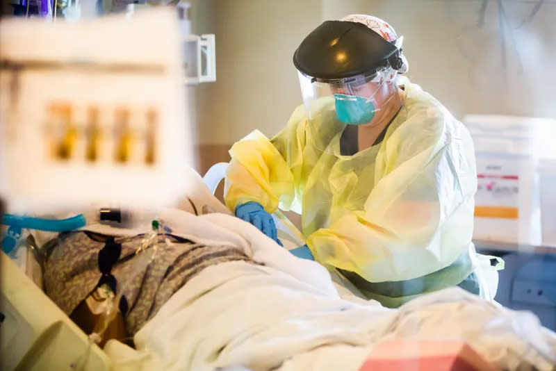 Image: Allison Moore, medical ICU nurse, helps a COVID-19 patient at the University of Mississippi Medical Center. (Joe Ellis / University of Mississippi Medical Center Communications)