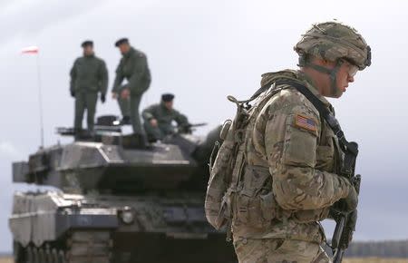 A U.S. soldier walks to the welcoming ceremony at polygon near Orzysz, Poland, April 13, 2017. REUTERS/Kacper Pempel