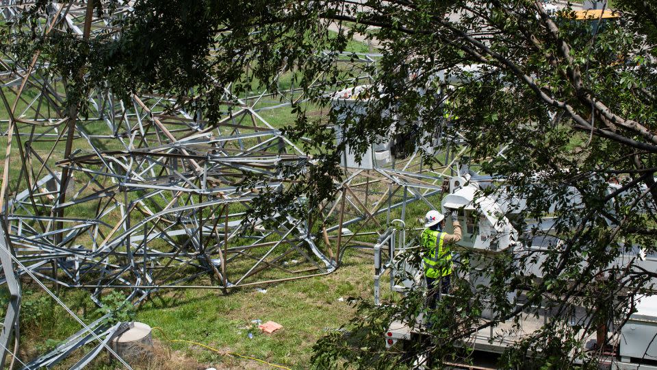 CenterPoint Energy employees work to repair damaged lines on May 18, 2024, after violent storms caused widespread damage and power outages in Houston, Texas. - Kaylee Greenlee Beal/Reuters