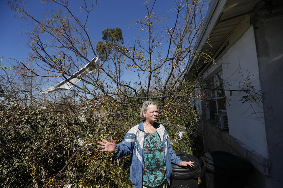 In this Oct. 13, 2018 photo, Mary Frances Parrish reacts outside her damaged home, in the aftermath of Hurricane Michael in Panama City, Fla. In the days after Hurricane Michael smashed through her neighborhood, leaving many of her neighbors’ homes destroyed, she and her son Derrell, were planning to stay, with or without running water and electricity. The reason is the same she waited out the storm in the tiny house: She doesn’t have a running car and she doesn’t know where she would go. (AP Photo/Gerald Herbert)