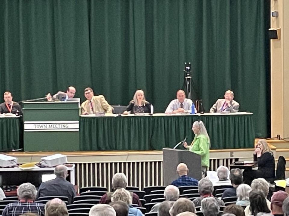 Falmouth town meeting members discuss the town budget for the upcoming fiscal year at the April 10 town meeting. The budget was unanimously approved at $153.8 million.