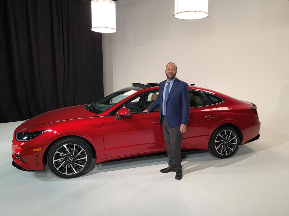 Karl Brauer, executive editor of Kelley Blue Book, is standing beside a 2020 Hyundai Sonata at a broadcast studio on November 26th, 2019 in Los Angeles.