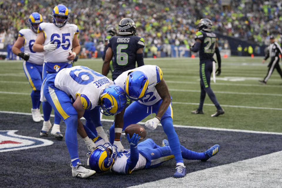 Los Angeles Rams wide receiver Tutu Atwell, bottom, celebrates his touchdown catch with teammates during the first half of an NFL football game against the Seattle Seahawks Sunday, Jan. 8, 2023, in Seattle. (AP Photo/Stephen Brashear)