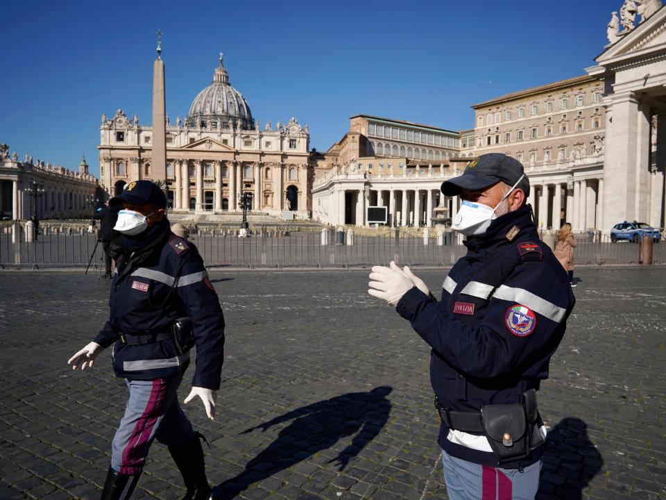 Police officers wearing masks patrol an empty St. Peter's Square at the Vatican, Wednesday, March 11, 2020. Pope Francis held his weekly general audience in the privacy of his library as the Vatican implemented Italy’s drastic coronavirus lockdown measures, barring the general public from St. Peter’s Square and taking precautions to limit the spread of infections in the tiny city state.For most people, the new coronavirus causes only mild or moderate symptoms, such as fever and cough. For some, especially older adults and people with existing health problems, it can cause more severe illness, including pneumonia. (AP Photo/Andrew Medichini)