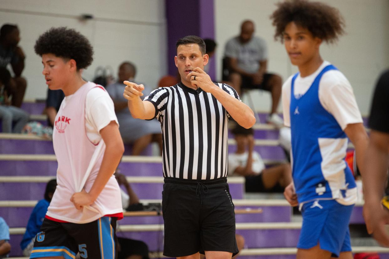 KSHSAA official Cooper Moore makes a call during a summer tournament game between Highland Park and Junction City at Topeka West in June 2022. A bill in the House Education Committee would criminalize abuse of sports officials.