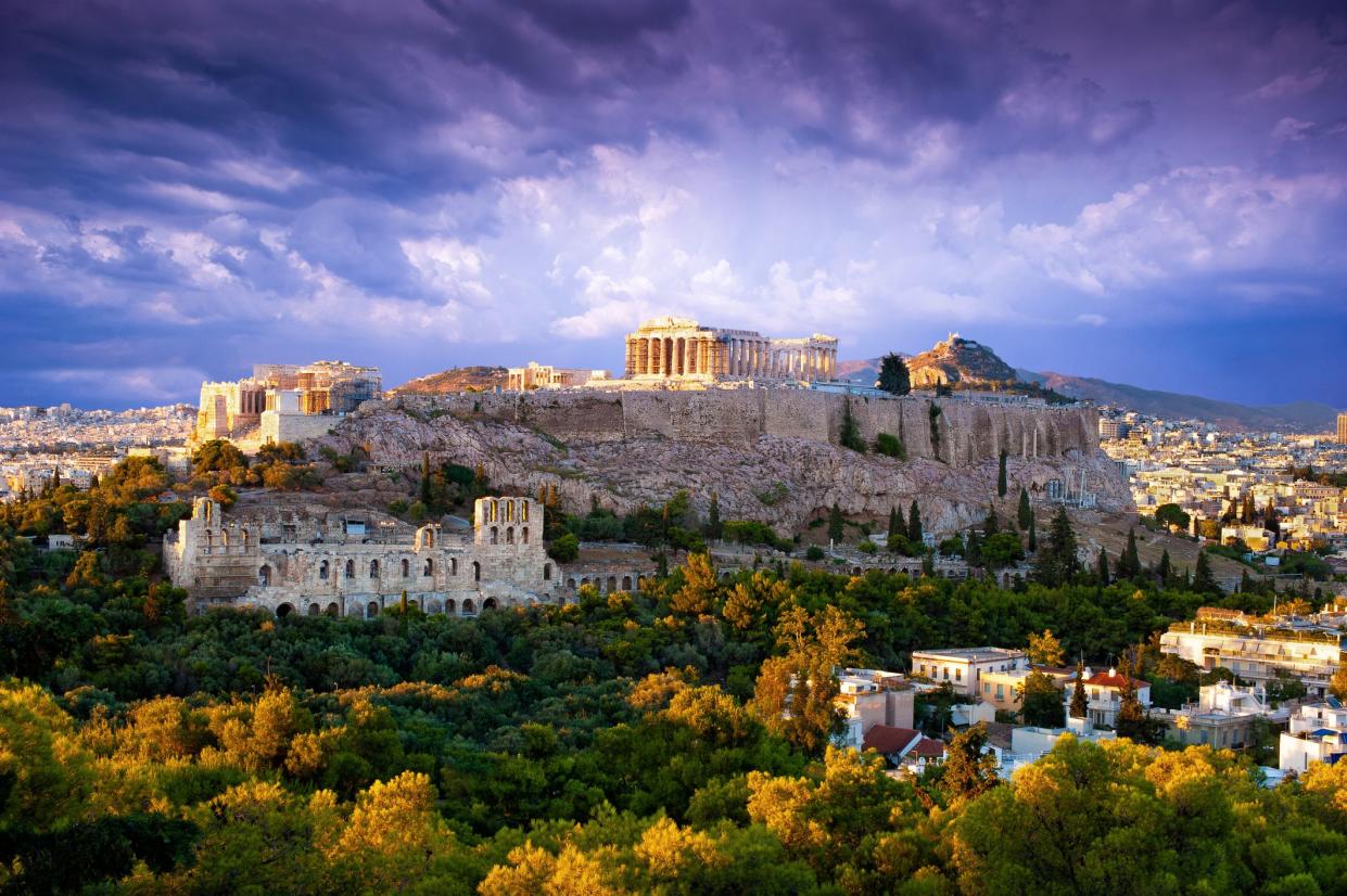 Parthenon Temple and Odeon of Herodes Atticus on Acropolis Hill at sunset, Athens, Greece, during fall