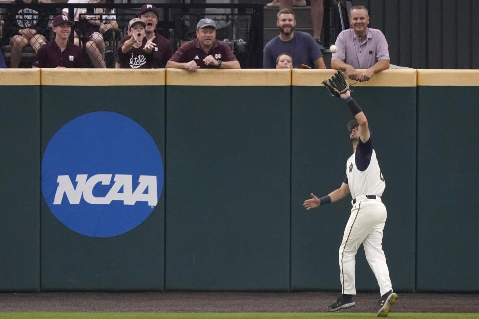 Mississippi State fans react as Notre Dame infielder Spencer Myers (2) catches a Mississippi State fly ball in the first inning of an NCAA college baseball super regional game, Sunday, June 13, 2021, in Starkville, Miss. Notre Dame won 9-1. (AP Photo/Rogelio V. Solis)