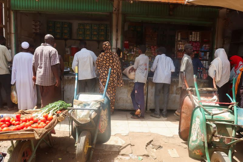 FILE PHOTO: Sudanese buy their groceries from a local vendor during the month of Ramadan in the city of Omdurman