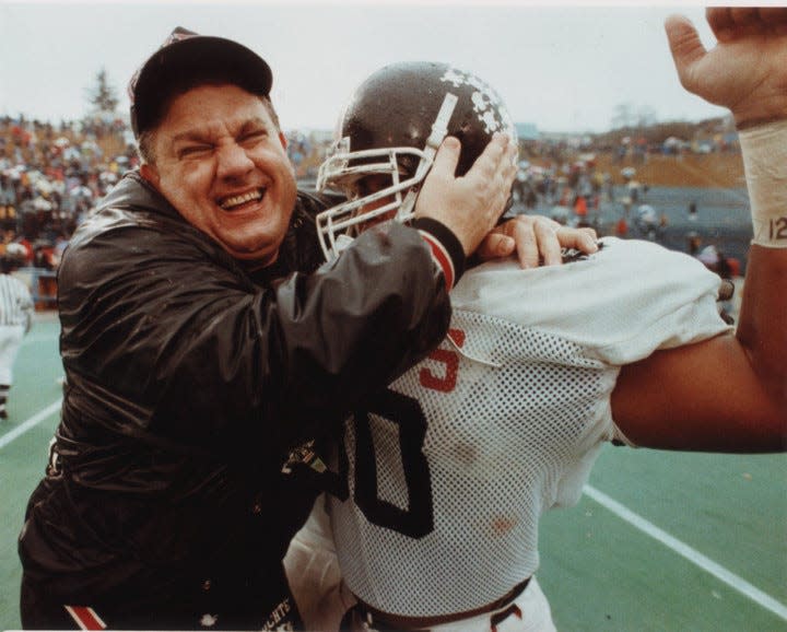 Tim Flossie celebrates with a Buchtel High School football player in an undated photo.