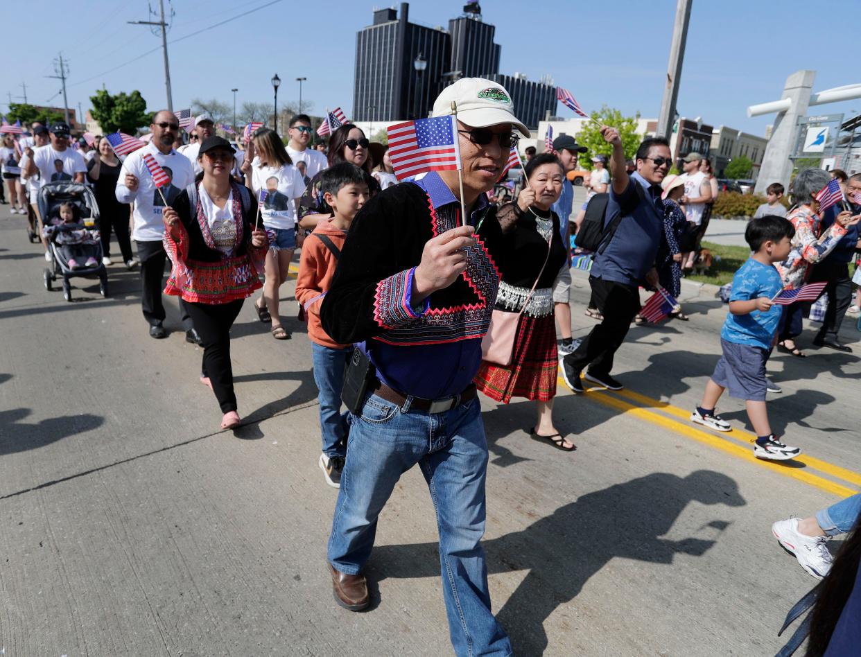 Hmong community members march in the Memorial Day parade, Monday, May 29, 2023, in Sheboygan, Wis.