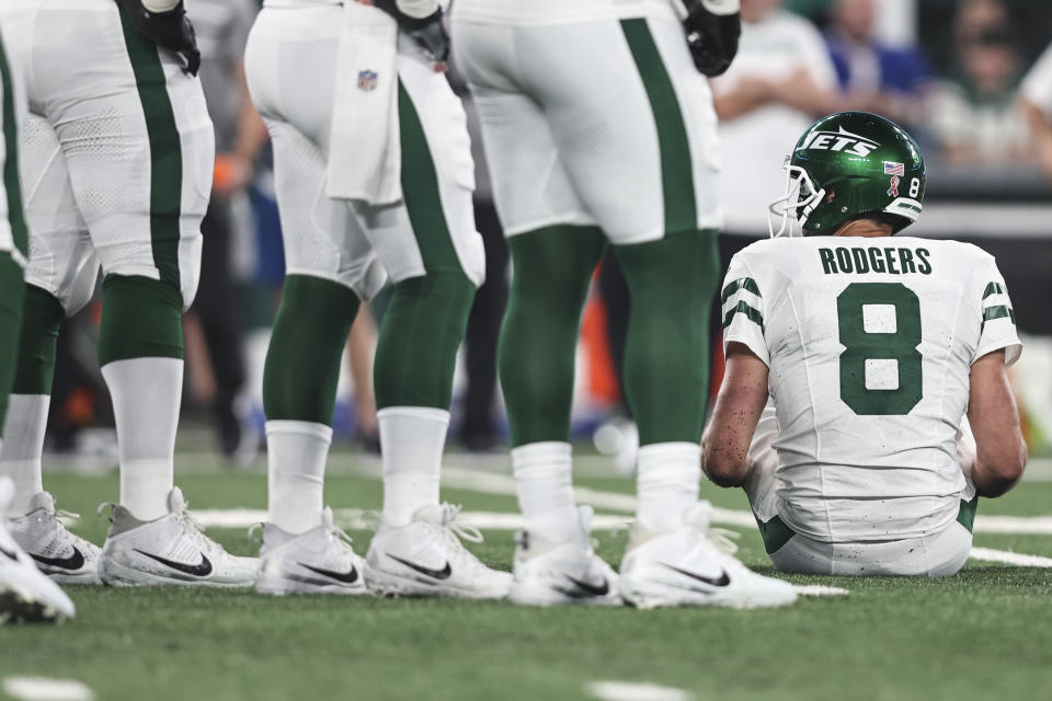 EAST RUTHERFORD, NEW JERSEY - SEPTEMBER 11: Aaron Rodgers #8 of the New York Jets sits down after an apparent injury after getting sacked by Leonard Floyd #56 of the Buffalo Bills prior to a game at MetLife Stadium on September 11, 2023 in East Rutherford, New Jersey. (Photo by Michael Owens/Getty Images)